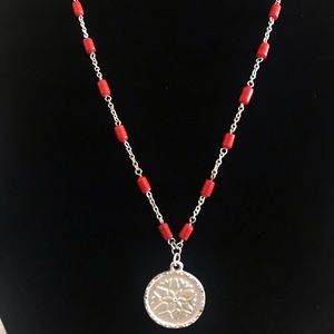 Long beaded necklace with pendent.